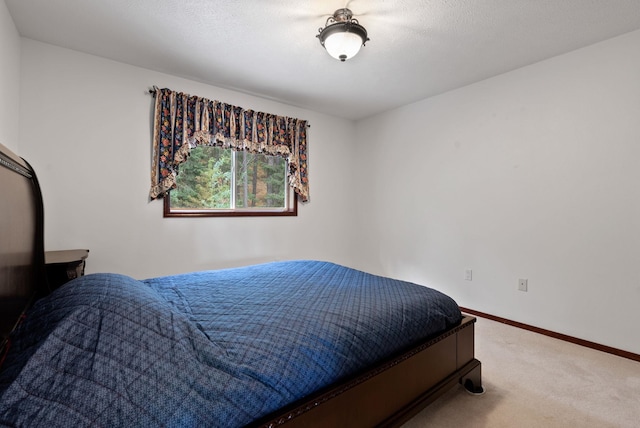 bedroom featuring baseboards and carpet flooring