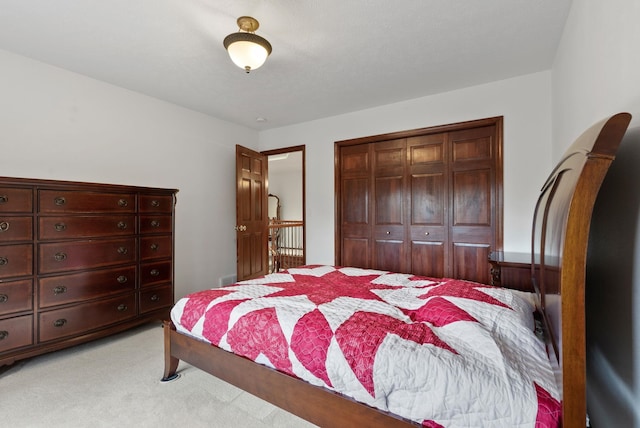 bedroom featuring light carpet and a closet