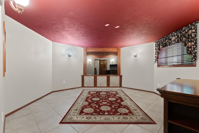 interior space featuring baseboards and a textured ceiling