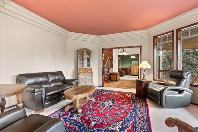 living area featuring carpet and crown molding