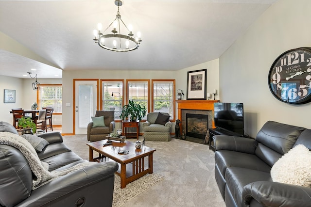 living room featuring a chandelier, a healthy amount of sunlight, light carpet, and a fireplace