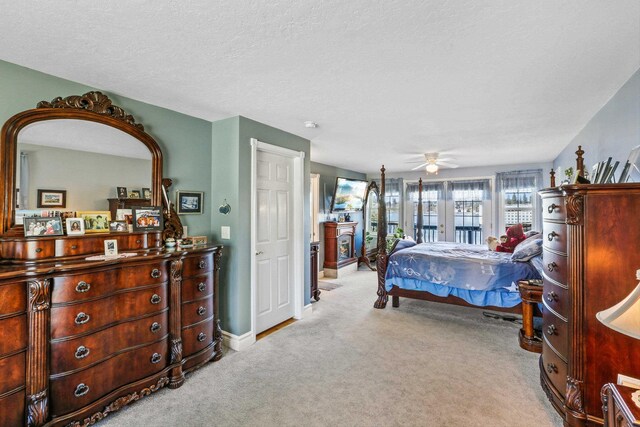 bedroom featuring a ceiling fan, carpet flooring, a textured ceiling, and baseboards