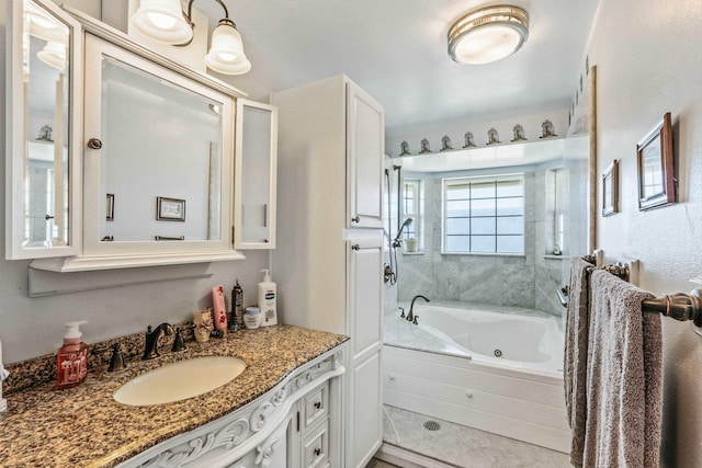 full bathroom with a shower, vanity, and a tub with jets