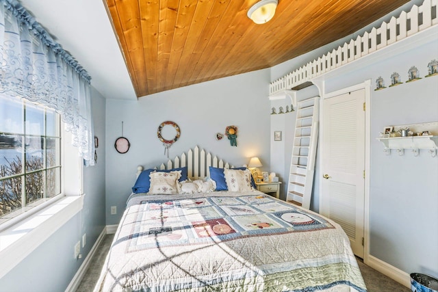 bedroom featuring wooden ceiling, baseboards, and carpet flooring