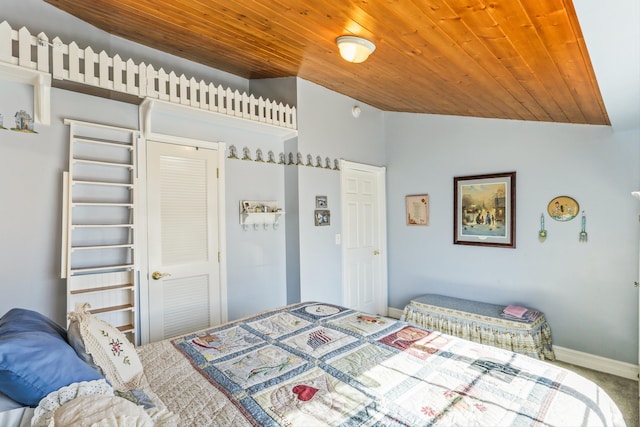 carpeted bedroom featuring lofted ceiling, wooden ceiling, and baseboards