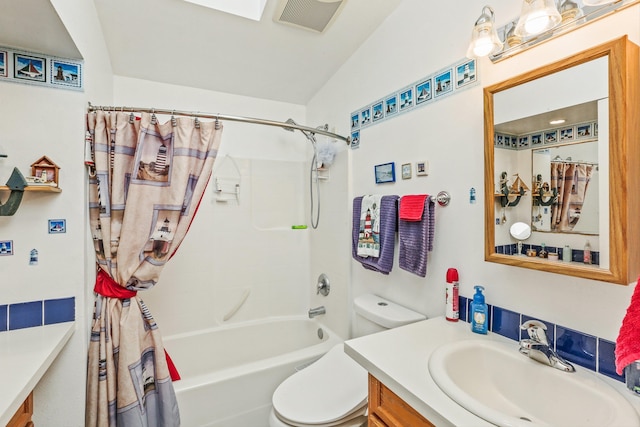 full bathroom featuring visible vents, shower / tub combo, vanity, and toilet