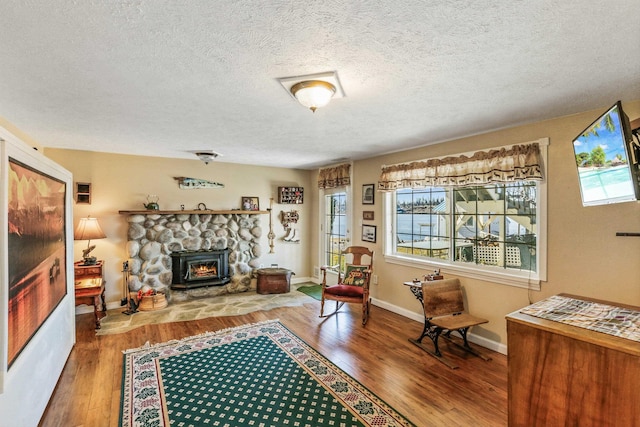 living room featuring baseboards, a wealth of natural light, and wood finished floors