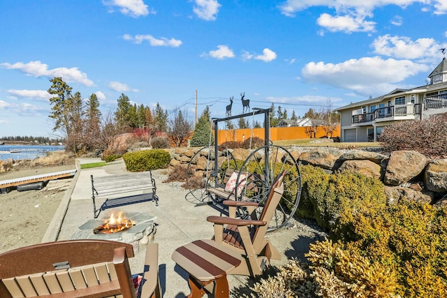 surrounding community with a patio area and a fire pit