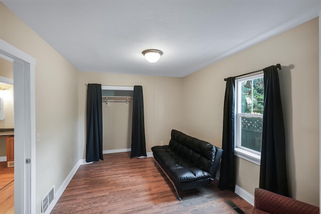 sitting room with visible vents, baseboards, and wood finished floors