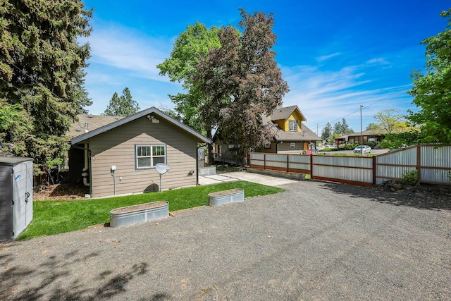 back of house with fence and a lawn