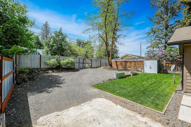 view of yard with an outbuilding and a fenced backyard