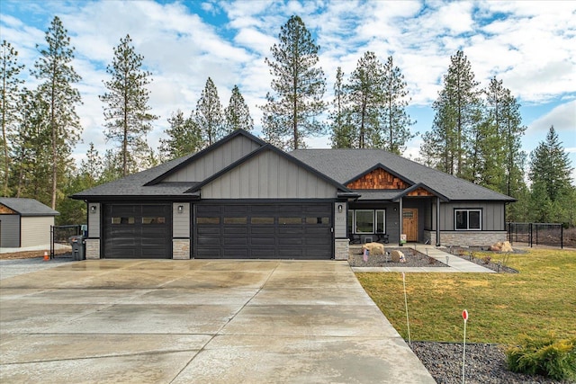 view of front of house featuring a garage, stone siding, board and batten siding, and concrete driveway