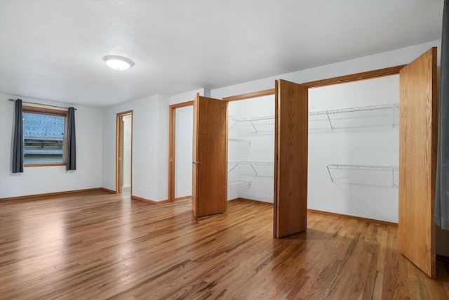 unfurnished bedroom featuring baseboards and wood finished floors