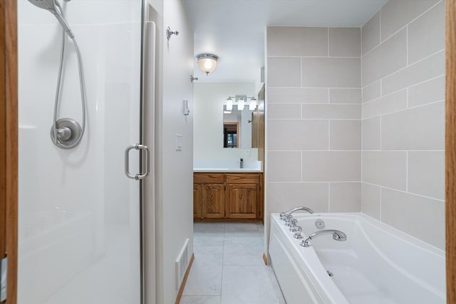 bathroom with visible vents, tile patterned floors, a garden tub, vanity, and a shower stall