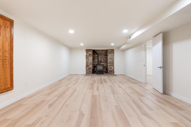 basement featuring light wood finished floors, baseboards, and recessed lighting