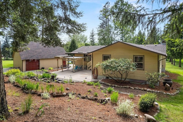 back of house with a patio