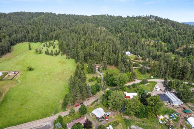 birds eye view of property featuring a wooded view