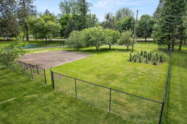 view of home's community featuring fence and a lawn