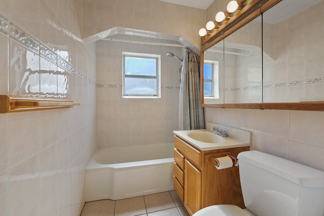 full bath with tile walls, shower / bathtub combination with curtain, toilet, vanity, and tile patterned floors