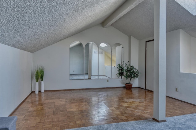 additional living space with vaulted ceiling with beams, a textured ceiling, and baseboards