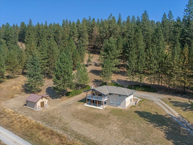 drone / aerial view with a wooded view