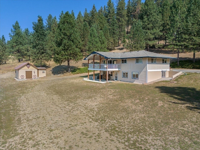 rear view of house featuring a yard