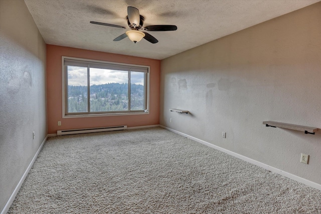 spare room featuring baseboards, a textured wall, baseboard heating, a textured ceiling, and carpet floors