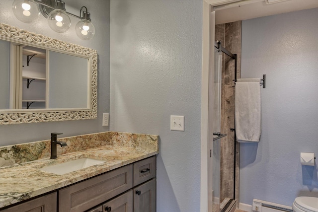 full bathroom with a baseboard heating unit, toilet, a shower stall, and vanity