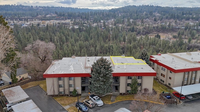 birds eye view of property featuring a view of trees