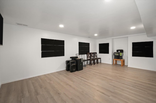 interior space with recessed lighting, light wood-type flooring, visible vents, and baseboards