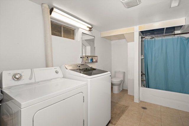 laundry area featuring laundry area, light tile patterned floors, and separate washer and dryer