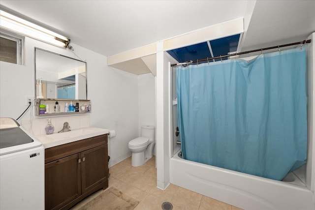 bathroom featuring washer / dryer, toilet, shower / tub combo with curtain, tile patterned flooring, and vanity