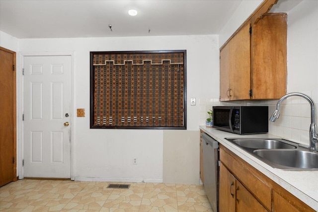 kitchen with light countertops, visible vents, a sink, and stainless steel dishwasher