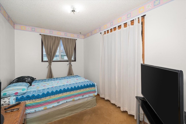 bedroom featuring a textured ceiling and carpet floors