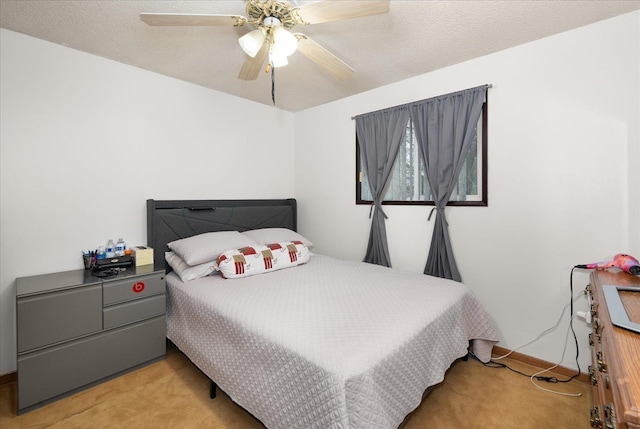 bedroom with carpet, ceiling fan, and a textured ceiling