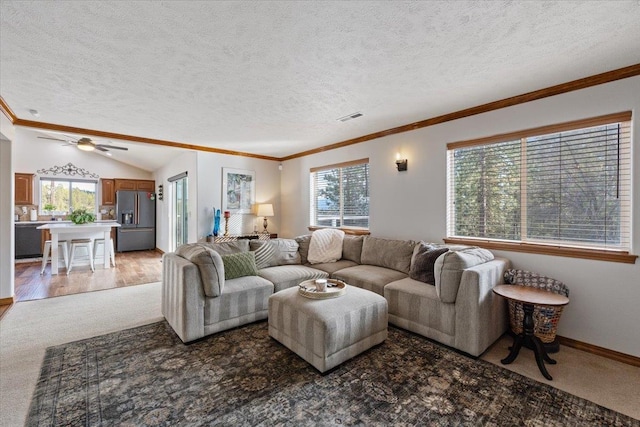 living room featuring ornamental molding, visible vents, and plenty of natural light