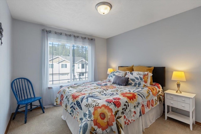 bedroom with carpet floors, a textured ceiling, and baseboards