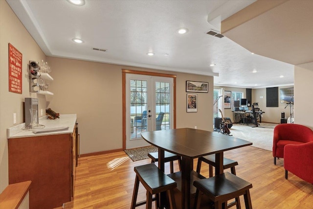 dining area featuring recessed lighting, visible vents, baseboards, light wood-style floors, and french doors