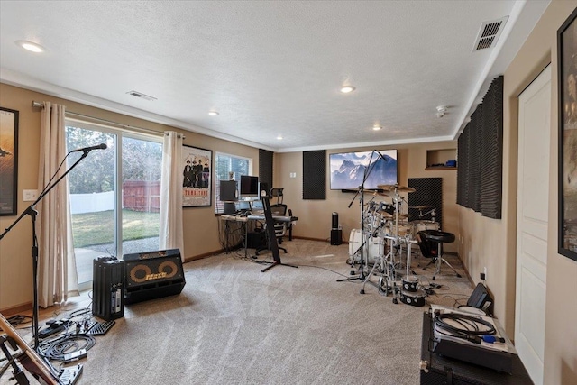 workout room featuring a textured ceiling, carpet floors, visible vents, and baseboards