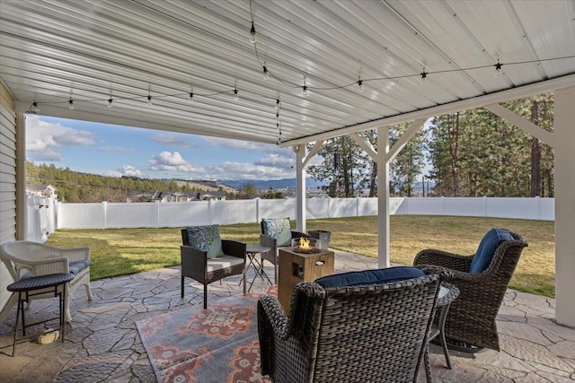 view of patio / terrace featuring an outdoor fire pit and a fenced backyard