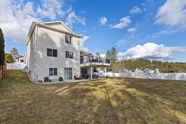 rear view of property with a patio area, a fenced backyard, and a yard