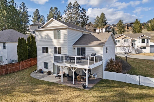 rear view of house featuring a patio, cooling unit, a fenced backyard, a yard, and a gate