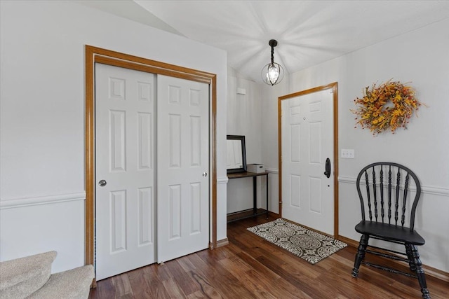 foyer featuring dark wood finished floors and baseboards