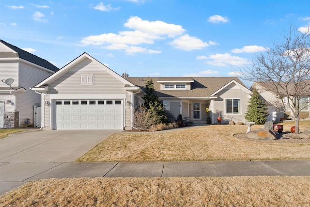 traditional-style home with a shingled roof, concrete driveway, and a front lawn