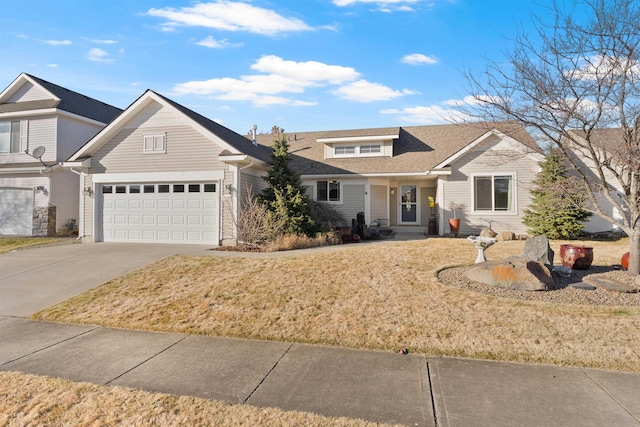 view of front facade with a garage, a front lawn, and concrete driveway