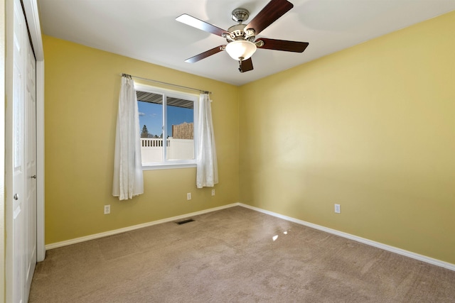 unfurnished room with a ceiling fan, baseboards, visible vents, and carpet flooring