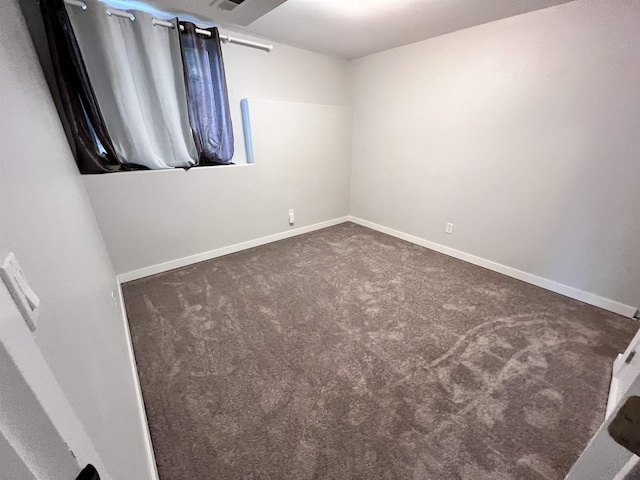 carpeted spare room with baseboards