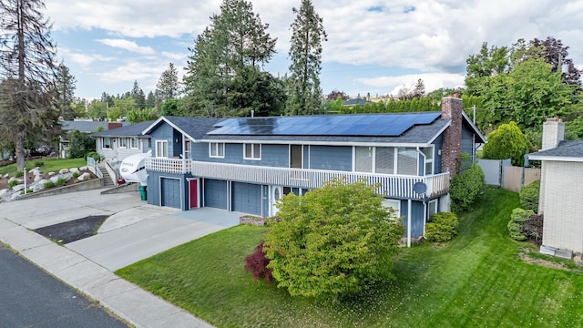 6514 N Sutherlin St, Spokane, WA 99208 - view of front facade featuring a garage, solar panels, concrete driveway, and stairway