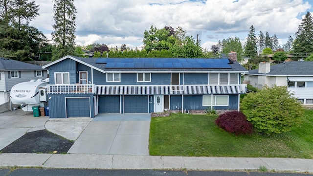 6514 N Sutherlin St, Spokane, WA 99208 - view of front of home with solar panels, a front lawn, driveway, and a garage