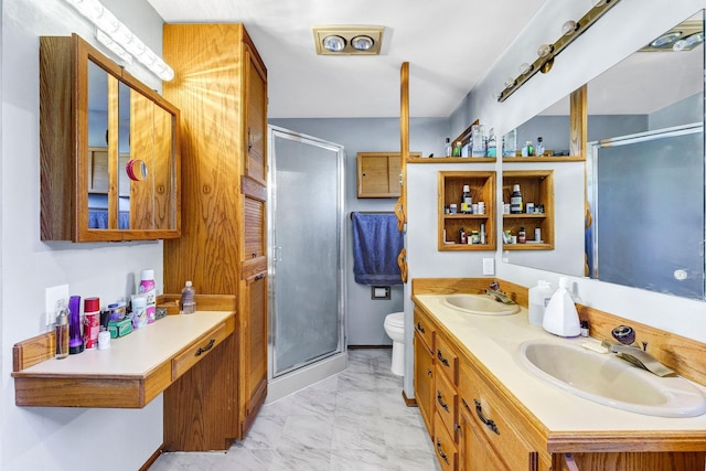 bathroom featuring a stall shower, marble finish floor, a sink, and toilet